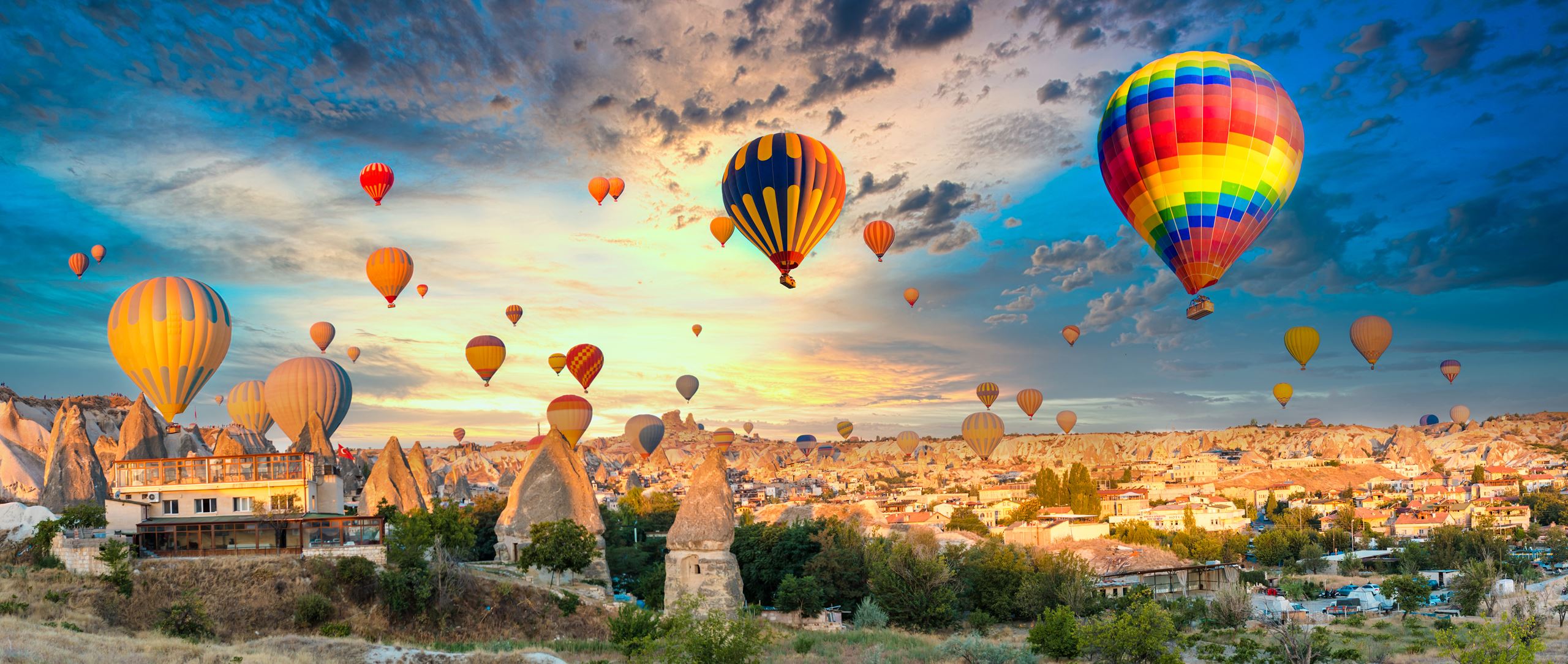 Hot air balloons in the sky over a desert